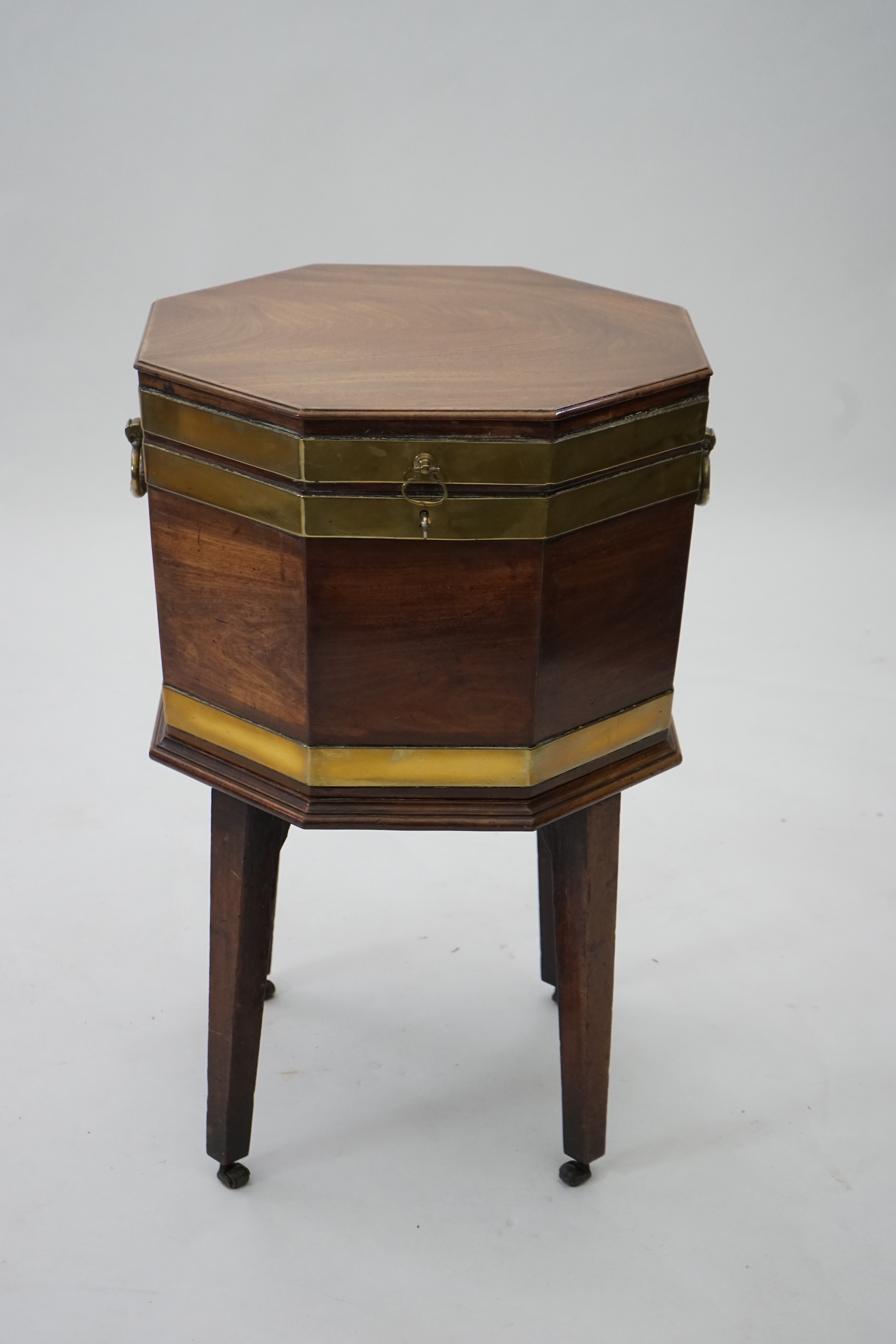 A George III mahogany triple brass banded octagonal cellarette